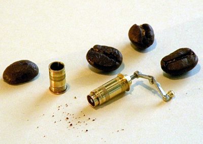 A tiny brass coffee grinder.