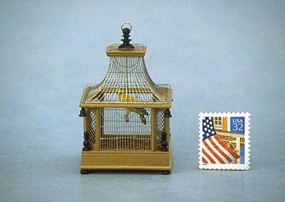 A tiny brass bird cage.