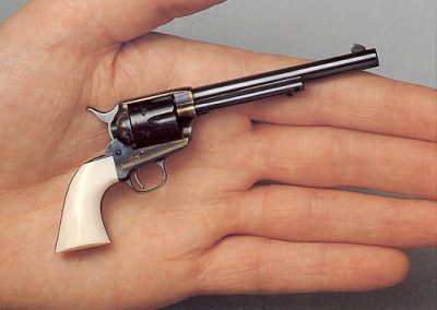 A miniature Colt Model 1873 Army or “Peacemaker” revolver.