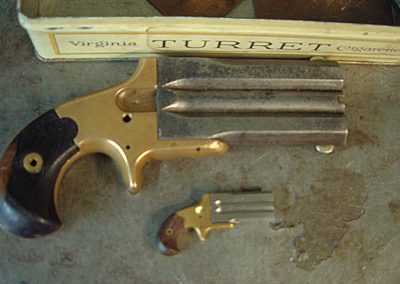 A full-size Derringer sits above David’s 1/3 scale model.