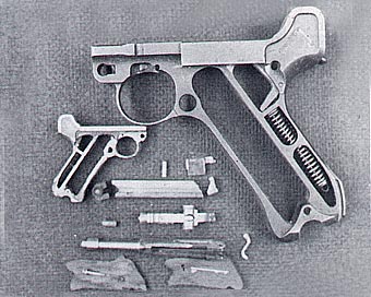 A full-size Luger P.08 frame alongside David’s miniature frame and related pieces.