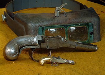 A full-size and miniature Queen Anne pistol.