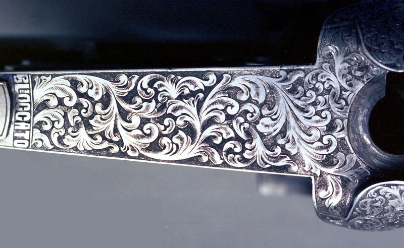 The top tang of a Perazzi over/under shotgun that Roger engraved.