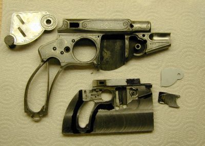 This photo shows the disassembled pistol and the model in an earlier stage of construction.