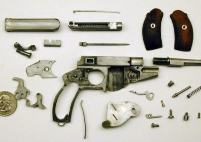 Only the miniature Bergmann is shown here, disassembled to its component parts.
