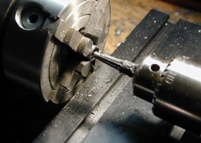 This photo shows the chamber being reamed by Roger on a Sherline lathe.