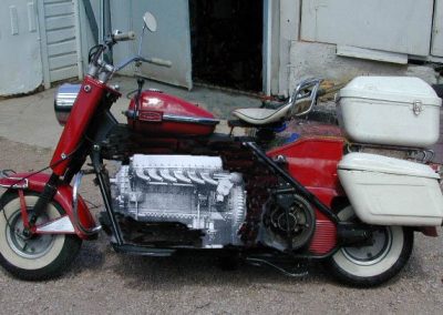 This digitally edited photo shows what a Cushman scooter would look like with a 1/3 scale Rolls Royce Merlin V-12 aircraft engine