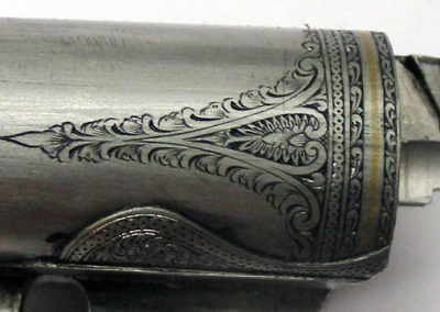 A side view of the engraving at the end of the barrel.