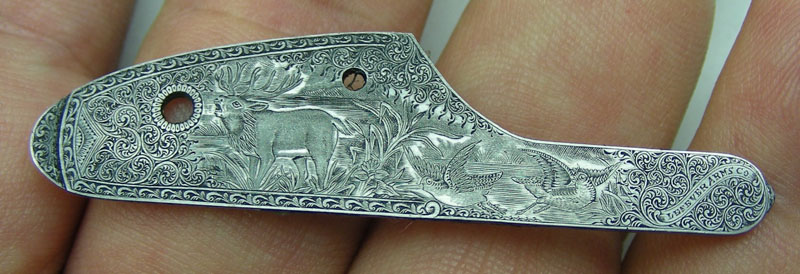 The other side plate, featuring more incredible engraving of an elk and birds.