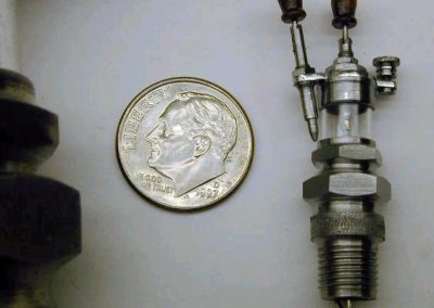 This photo shows a closer view of the miniature spark plug.