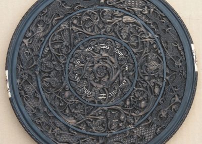 An intricate carved wooden plate.