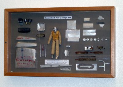 Some of Young's sample parts in a framed display.