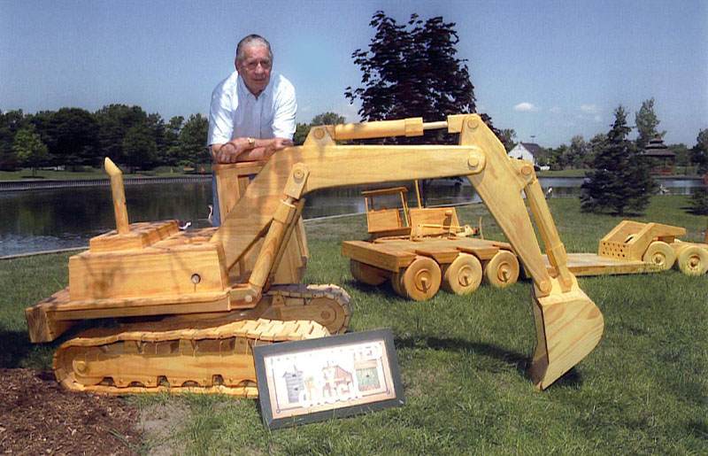Chuck poses behind his scale model excavator. 