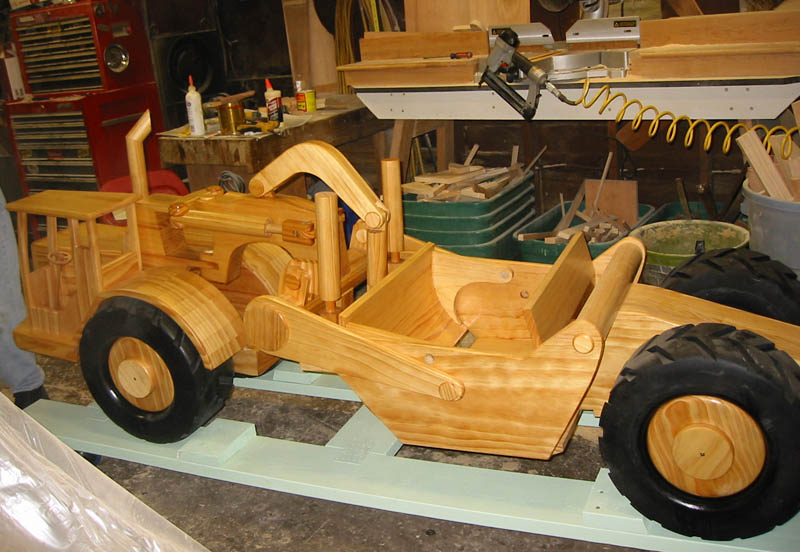 A wooden scale model scraper sits in Chuck’s shop.
