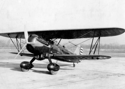 A black and white photo of an original full-size Curtiss-Wright P-6E Hawk biplane.