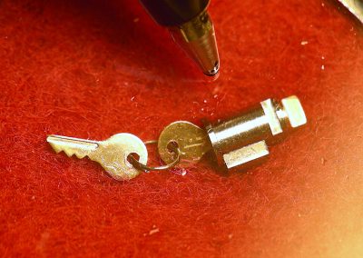 The tiny scale model ignition lock cylinder and keys.