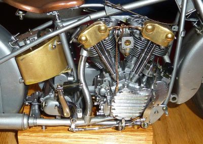 This side shows the kick starter pedal, carburetor, and brake lever.