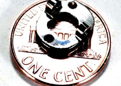 Bill's tiny Nanokey telegraph key sits on the surface of a penny.