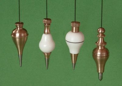 A set of brass and ivory plumb bobs in 1/3 scale.