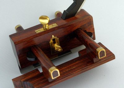 A plow plane with brass thumbscrews, and other brass features.