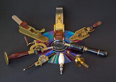 An array of John’s miniature tools sit on a CD for scale reference.
