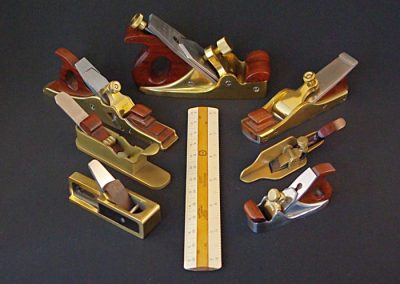 Several of John’s miniature planes with a ruler.