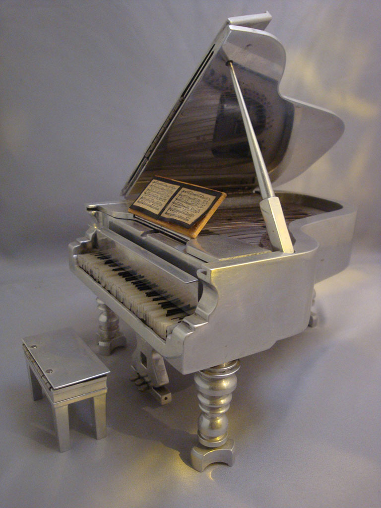 Another angle of the tiny aluminum grand piano.