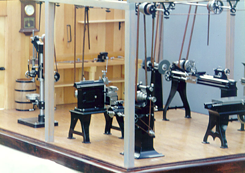 The overhead belt drive system is visible in this wide view of the miniature shop.