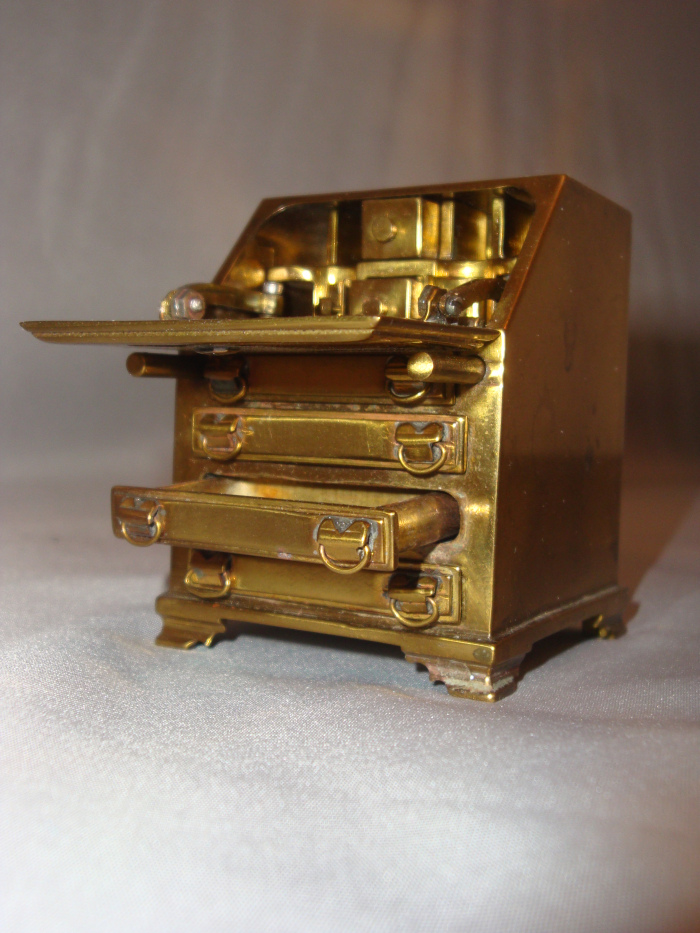 Abraham's miniature brass drop-leaf desk.