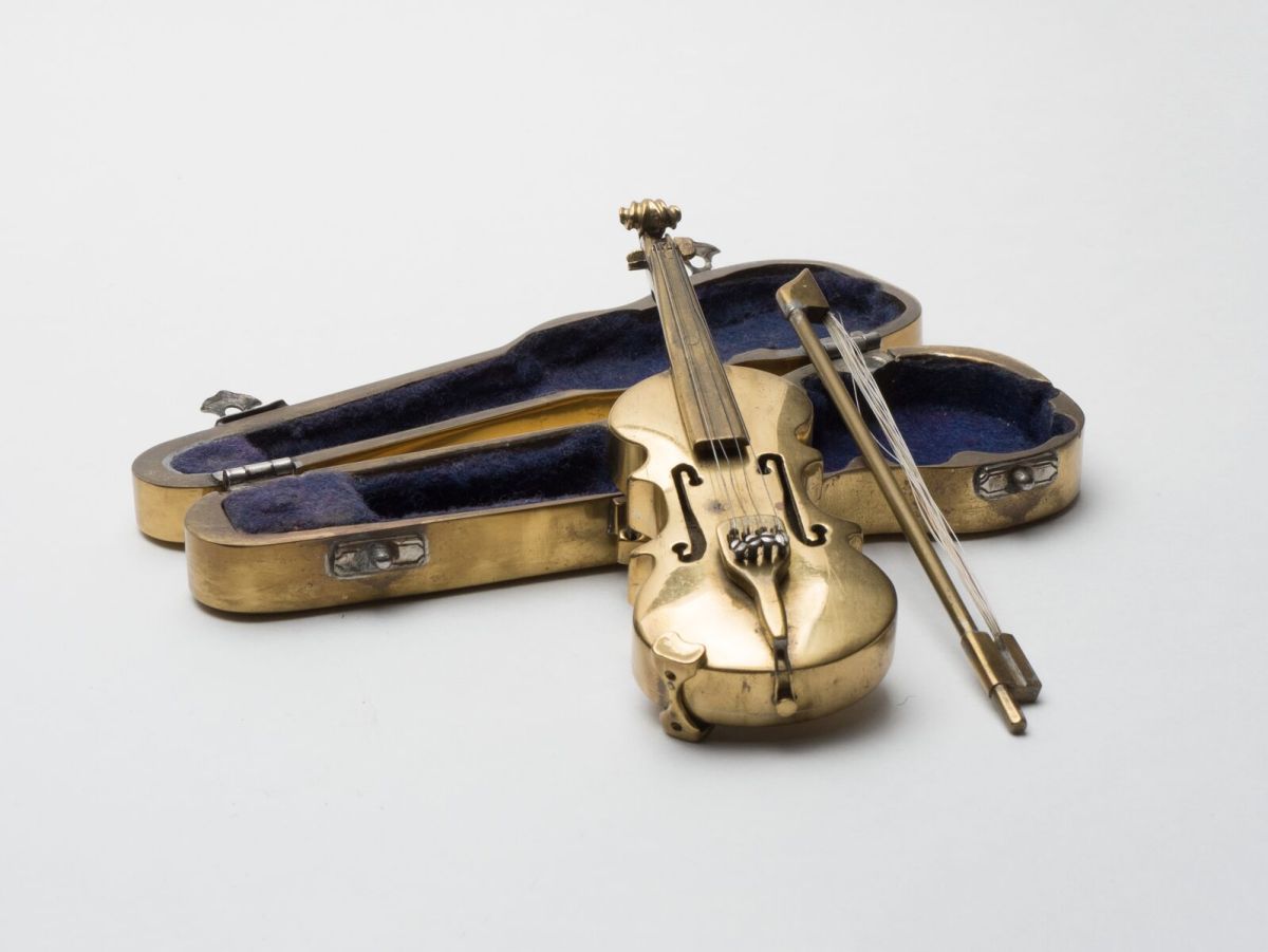 Working even smaller, Abe crafted this miniature brass violin.