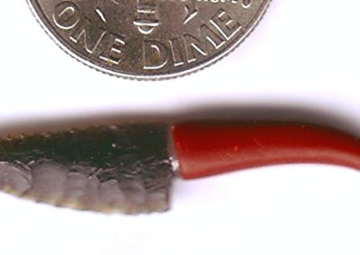 A miniature knife chipped from obsidian.