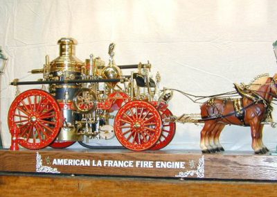 A full view of the fire engine and horses.