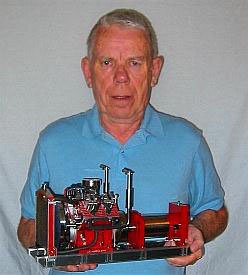 Jerry Howell holding his prototype V-4 engine. 