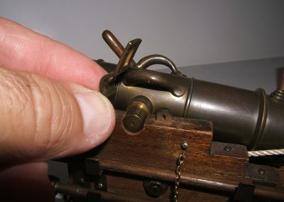 The cap plate secures the cannon barrel to the carriage.