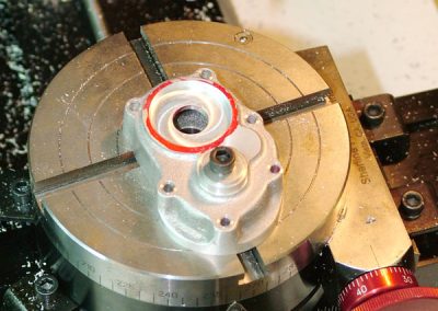 The timing cover was machined flat, and the mounting holes were drilled using a rotary table.