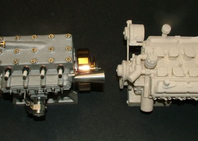 The Seal engine sits on the left, and on the right is a sample model V-8 produced with the 3D printer.