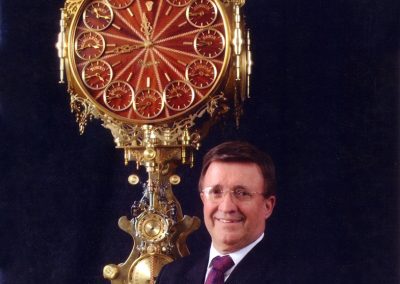 Germano with his giant 16-clock timepiece.
