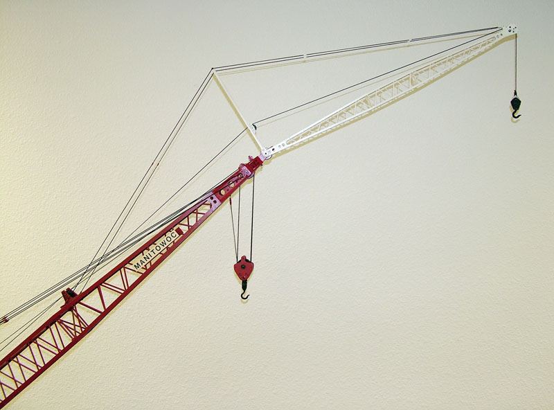 The optional white jib extends the reach of the boom by another 40 or 50 feet depending on the model.