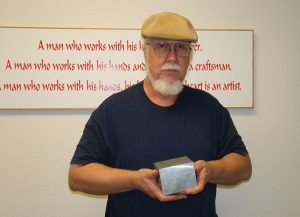 Tom holds the billet of aluminum that would become the engine block.