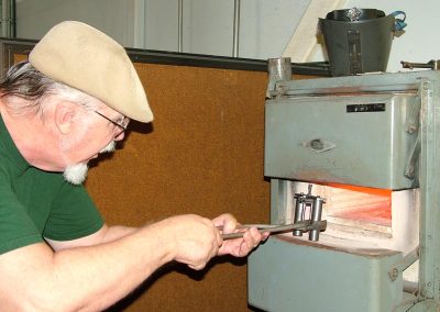 Tom inserts the fixture into the heat treating oven.