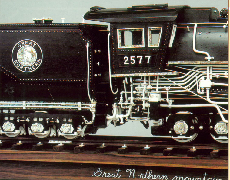 A side view of the cab shows steam lines, rivet details, and the beautiful goat logo.