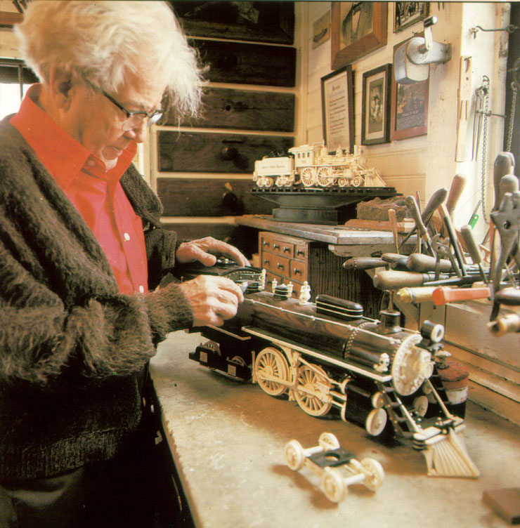 Mooney Warther at work on one of his locomotive carvings. 