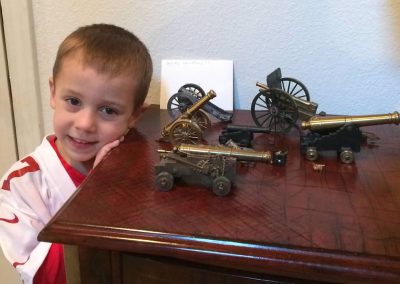 Sheridan’s grandson, Zachary with a collection of his grandfather’s model cannons.