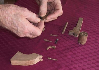 Robert assembles some of the component parts of a wooden Colt Pocket revolver.