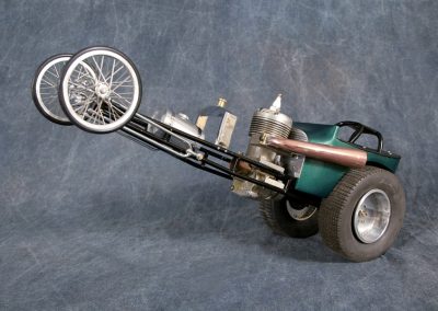 This front-engine altered dragster incorporates a model airplane engine for power.