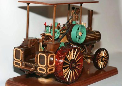 A steam traction engine features both raw wood and a few key painted parts.