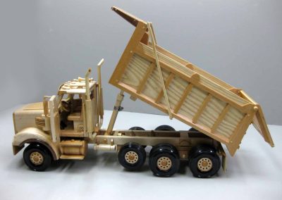 Sunia’s wooden dump truck is 21” long, 7” wide, and 9” tall.