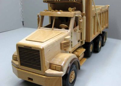 Sunia’s wooden dump truck is 21” long, 7” wide, and 9” tall.