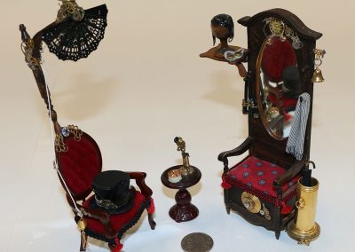 This 1/12 scale Ladies Parlor Chair and Hall Tree with Safe are part of Michael Sue Nanos’ collection.