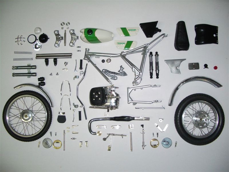 Components for the 1/5 scale OSSA trial bike are laid out before assembly.